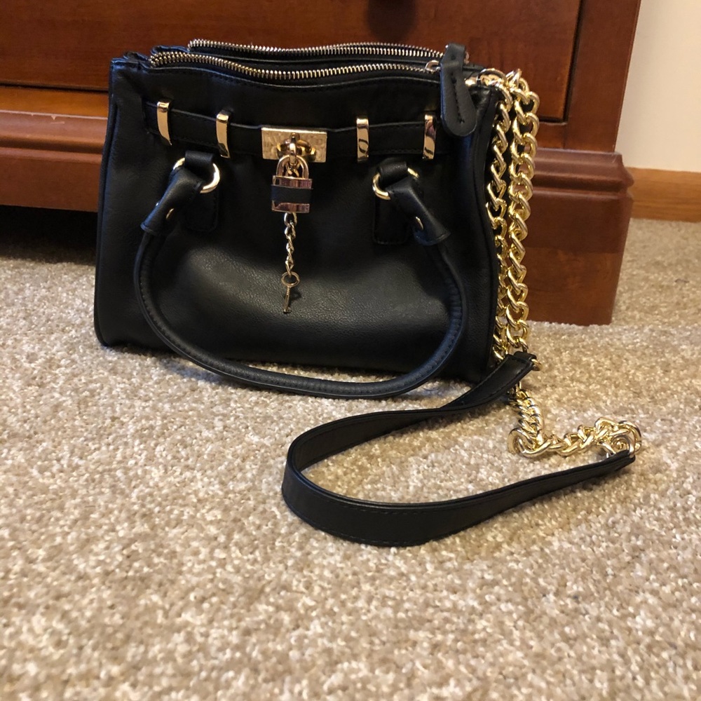 Black handbag with gold hardware, size is 10" x 8" x 4".